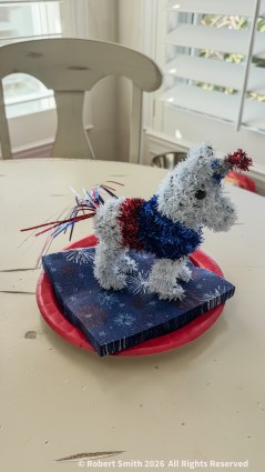 A festive unicorn decoration in red, white, and blue on a Fourth of July table setting.