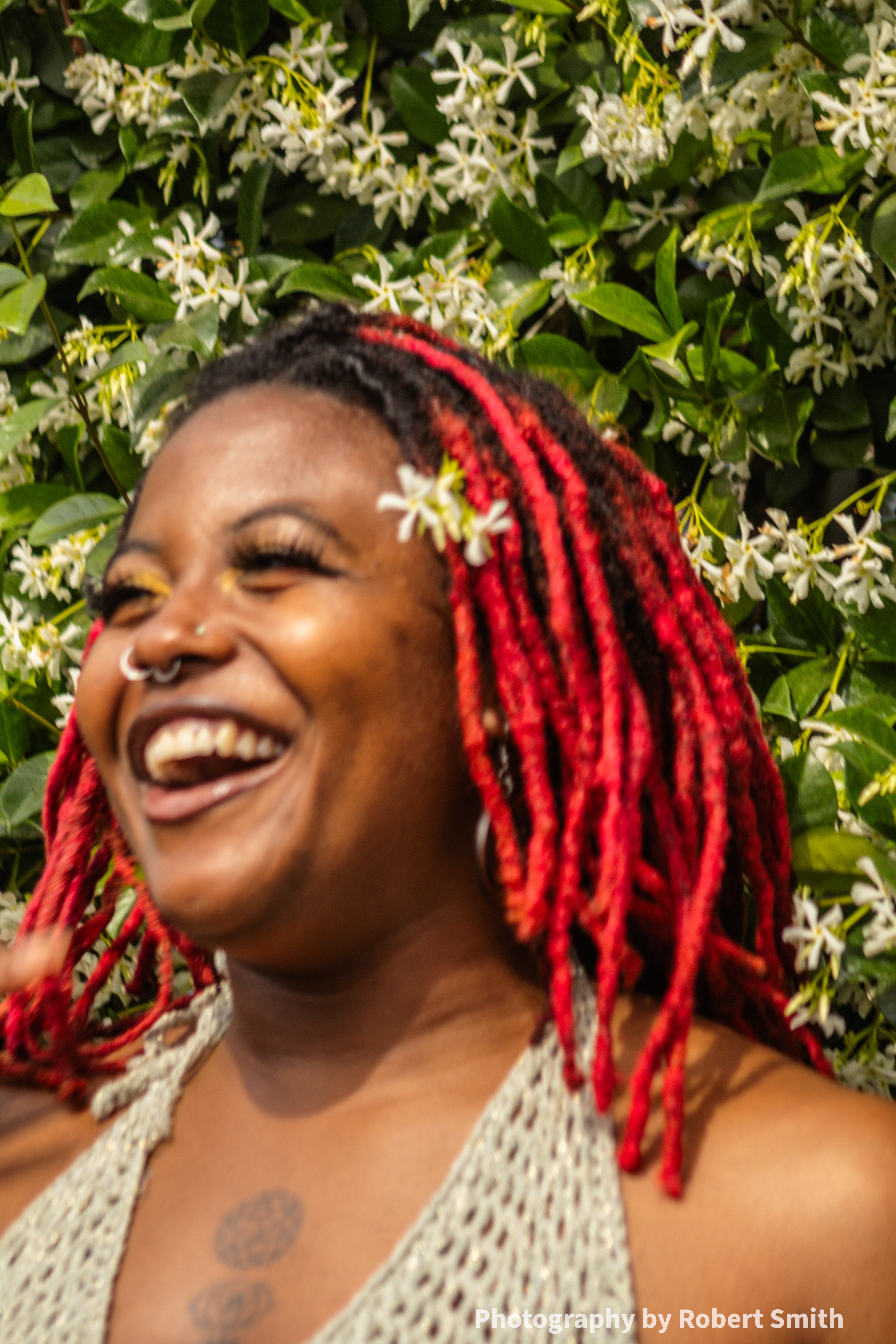 Girl laughing next to confederate jasmine